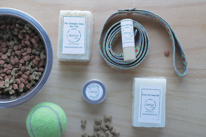 Pet shampoo soap bars with small round tin and rope, on light wood