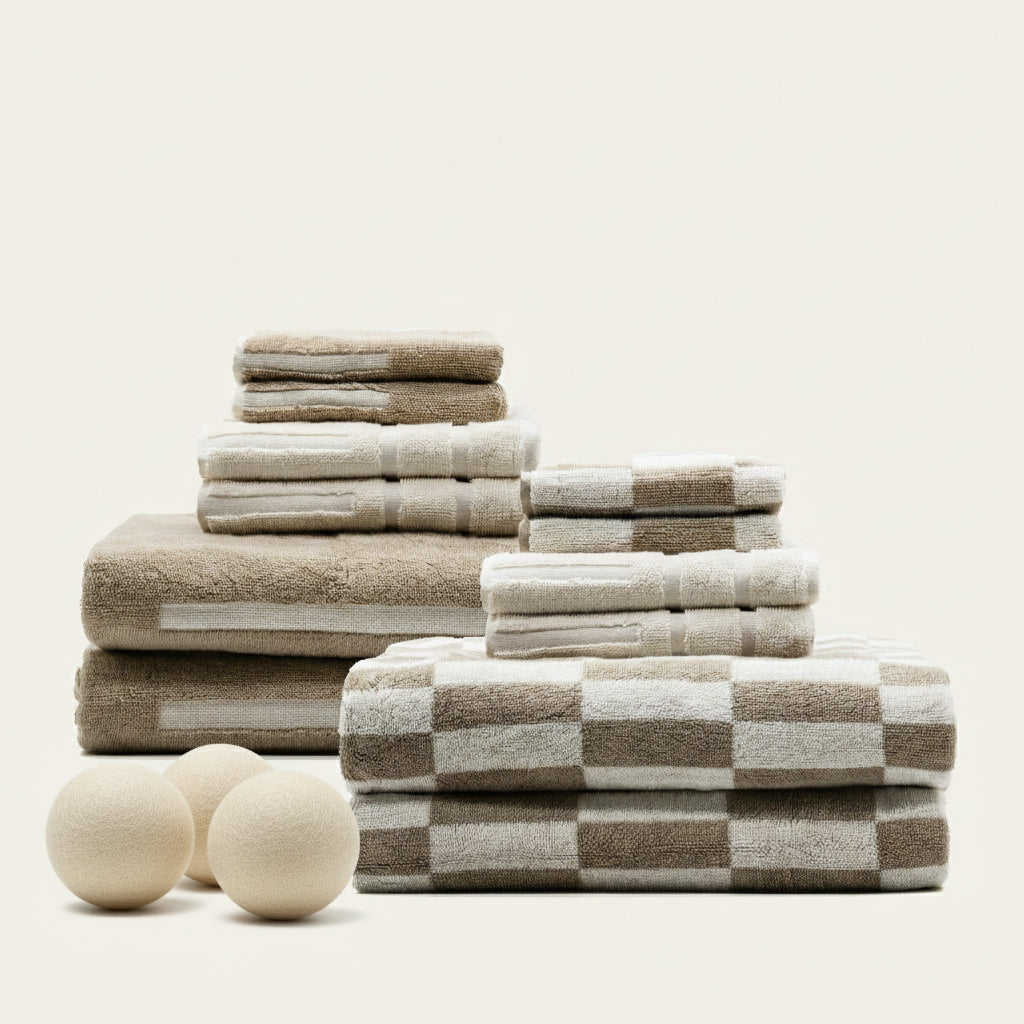 Folded beige and white checkered cotton towel set, neatly stacked