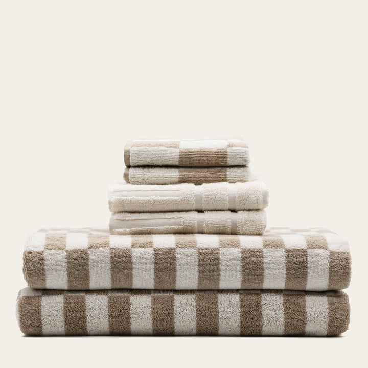 Cotton towels with beige and white stripe pattern, neatly stacked