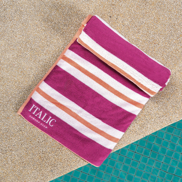 Cotton beach towel with magenta, white, and orange horizontal stripes, ITALIC logo
