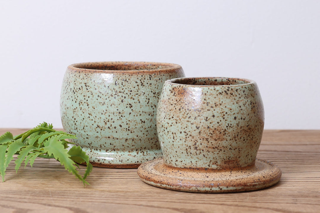Ceramic butter dish set with two cream speckled cups and bases, rustic glaze