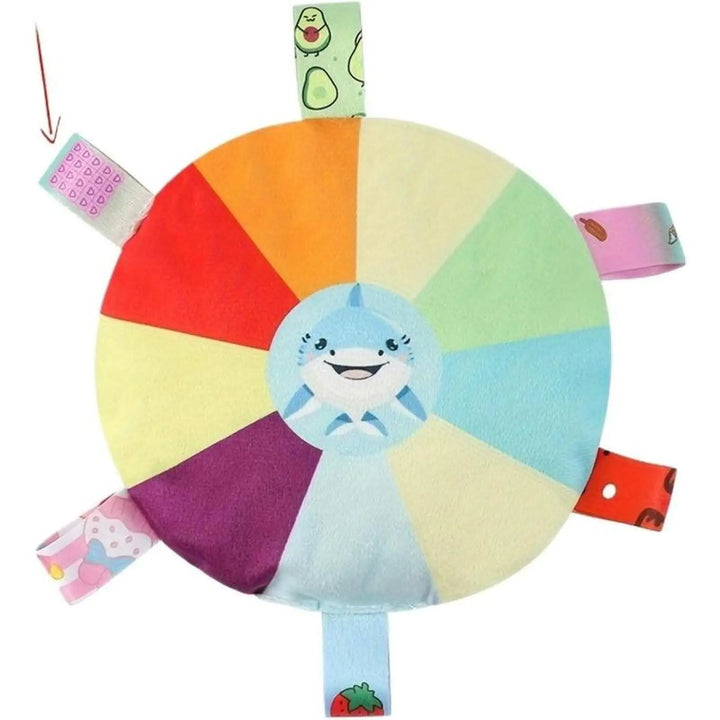 Plush flying disc dog chew toy with light blue shark face and dangling fabric ribbon tags