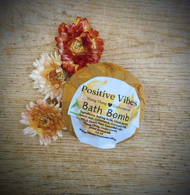 Kraft-labeled bath bomb round with dried red and white flower petals