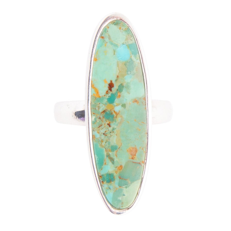 Oval turquoise stone ring with sterling silver oval bezel on white band