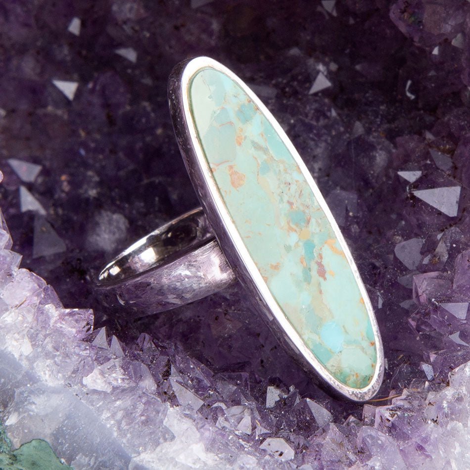 Turquoise oval ring with sterling silver frame and slim band
