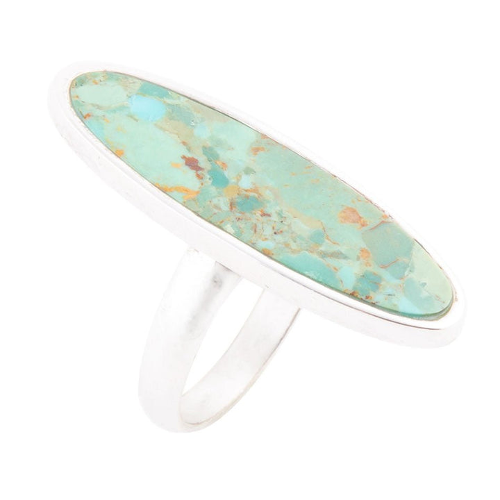 Oval turquoise cabochon ring in sterling silver bezel, white metal band