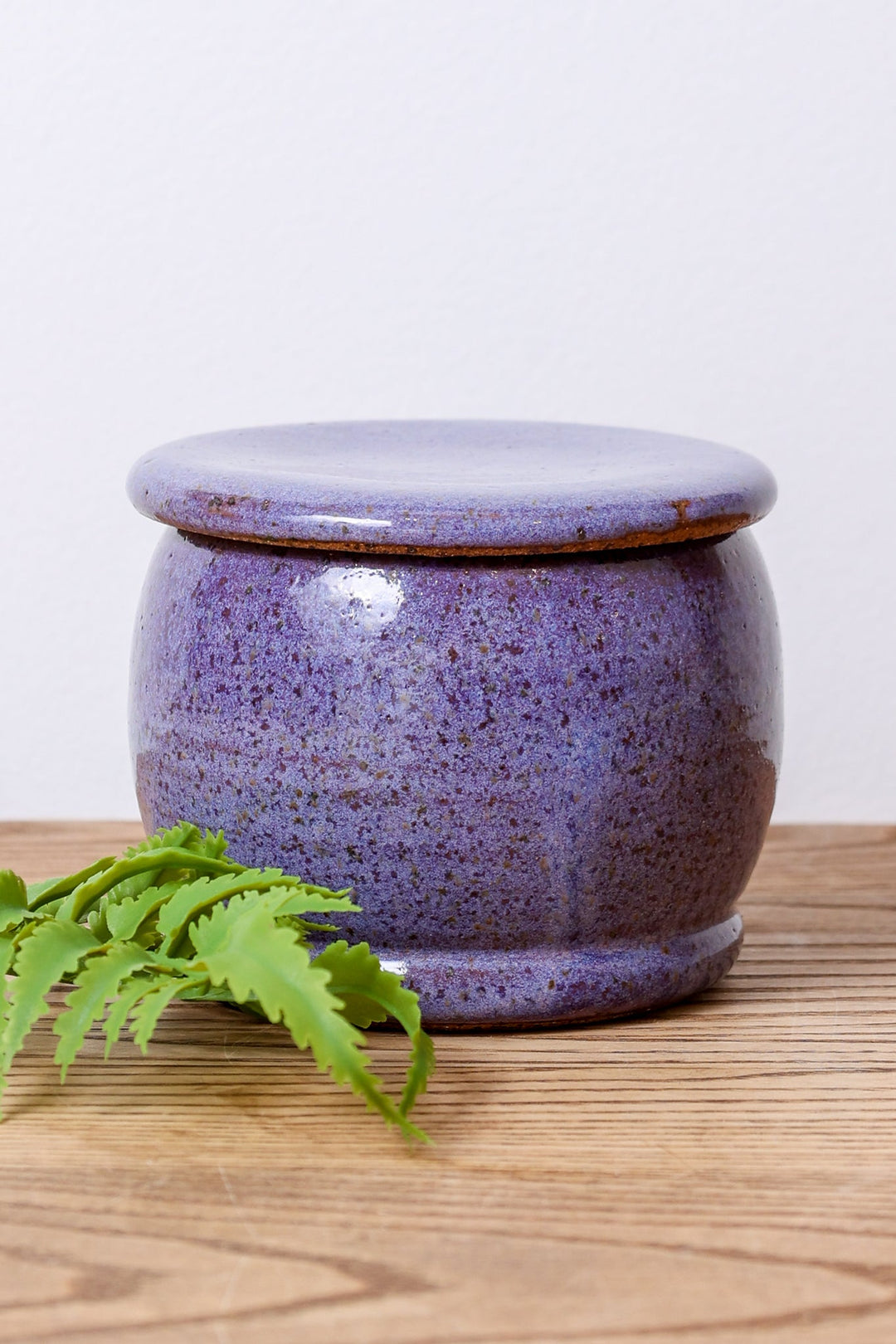 Ceramic butter dish with purple speckled jar and matching lid, round container