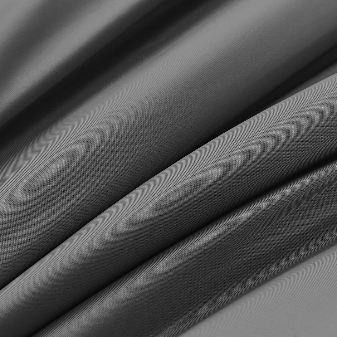 Dark gray cooling comforter fabric with smooth woven texture close-up