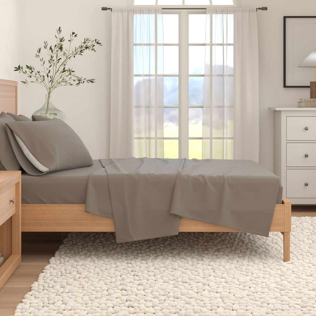 Grey cotton flannel sheet set draped over a bed
