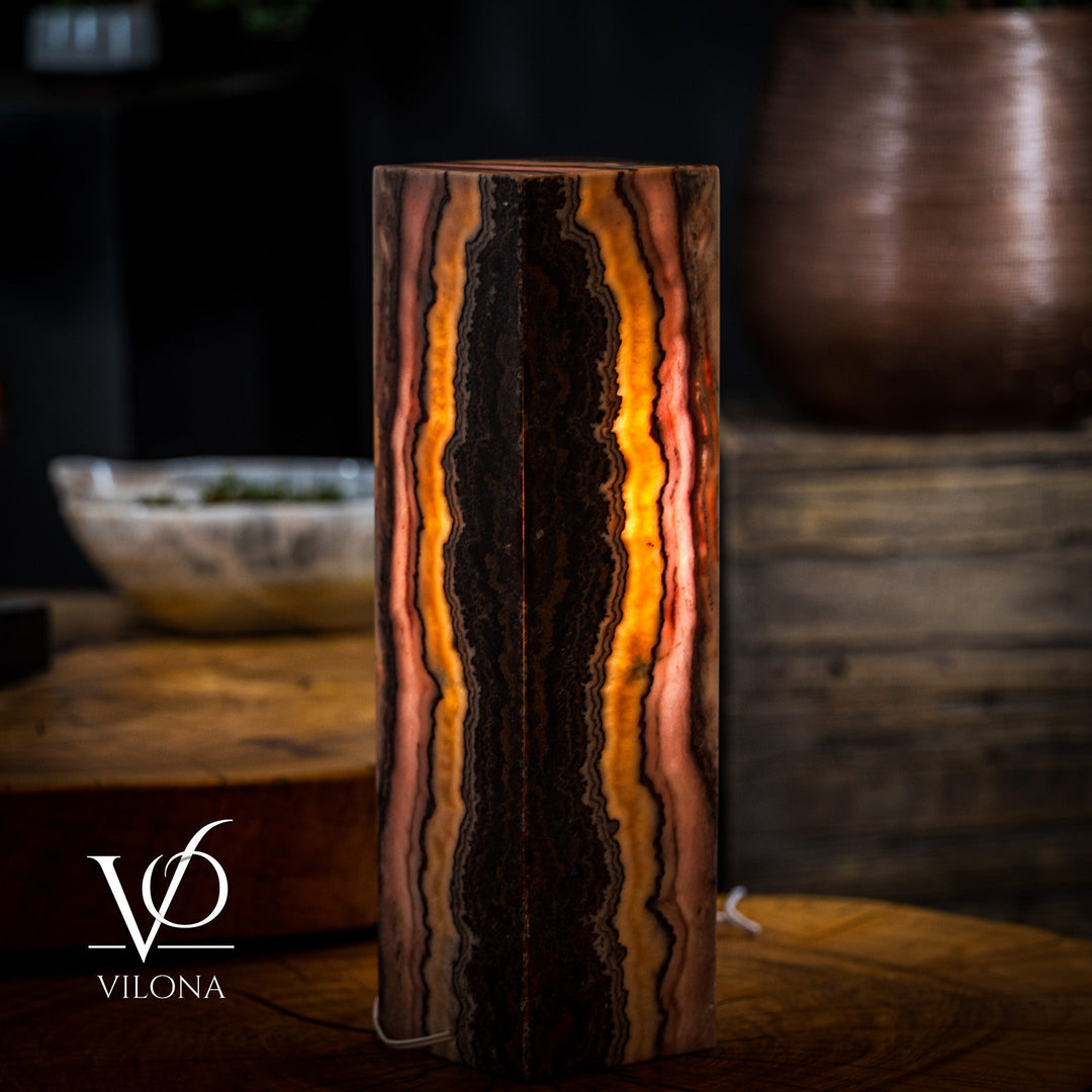 Tall rectangular onyx-style table lamp body, dark center with bright amber vertical stripes