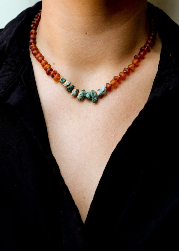 Amber and turquoise jasper bead necklace worn on neck with black shirt
