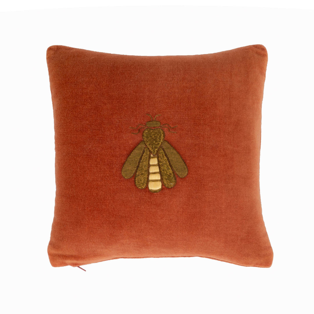 Rust orange velvet throw pillow cover with centered embroidered bee motif.