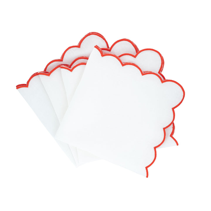 Scalloped linen napkins with red embroidered edge, folded stack