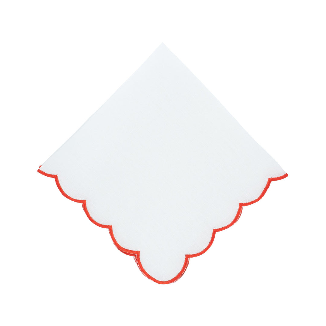 Scalloped linen napkin with red embroidered border, folded diamond shape