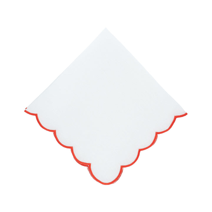 Scalloped linen napkin with red embroidered border, folded diamond shape