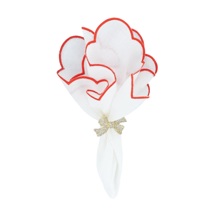 Scalloped linen napkin with red embroidered edge, heart motif and gold bow