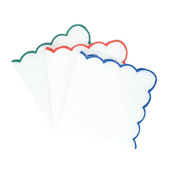 Scalloped linen napkins with green and blue embroidered edge trim, folded stack