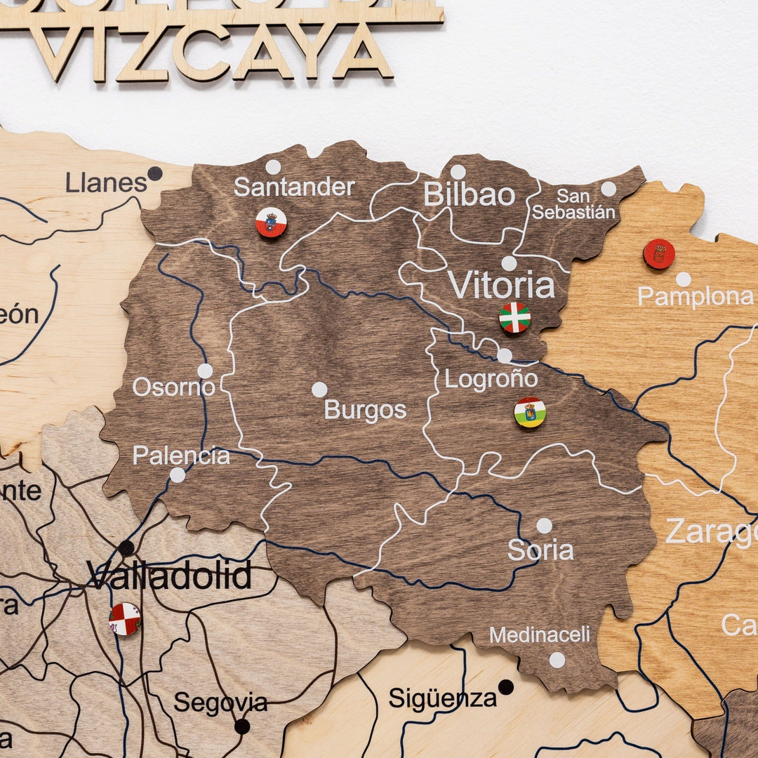 Close-up of wooden Spain wall map with raised city text and line borders