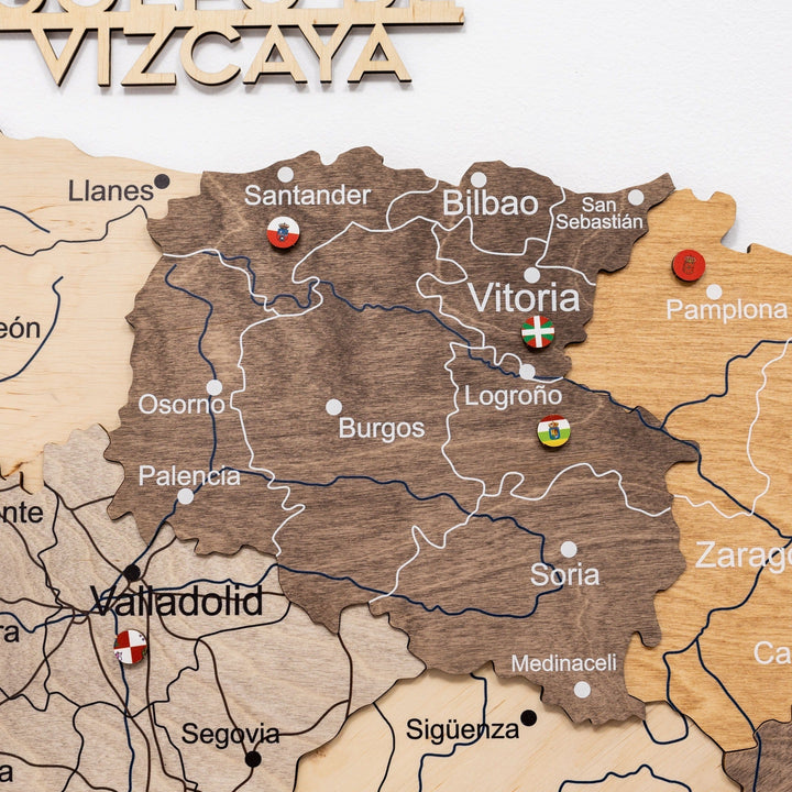 Close-up of wooden Spain wall map with raised city text and line borders