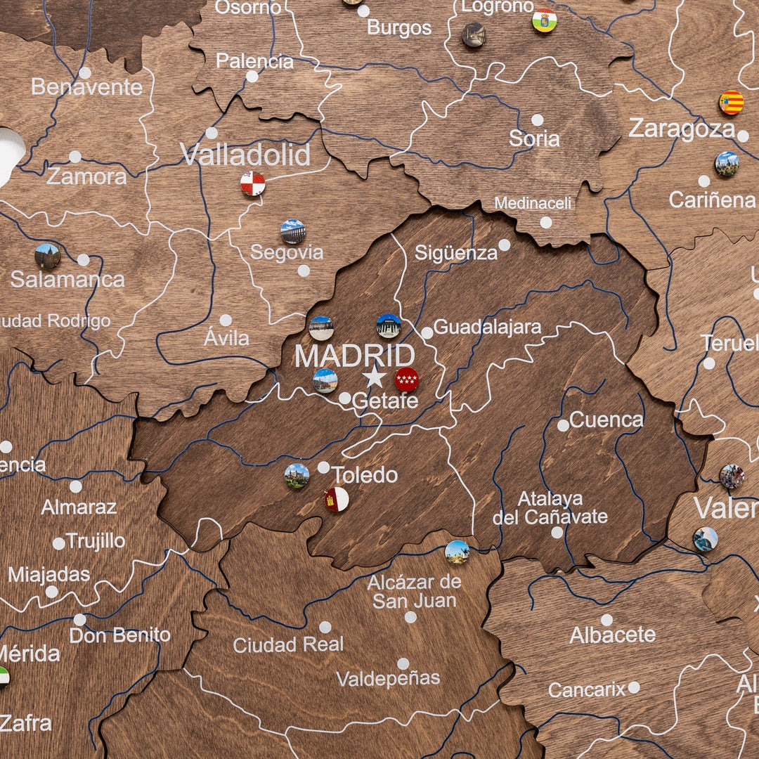 Dark walnut wooden Spain map close-up with Madrid label and route lines