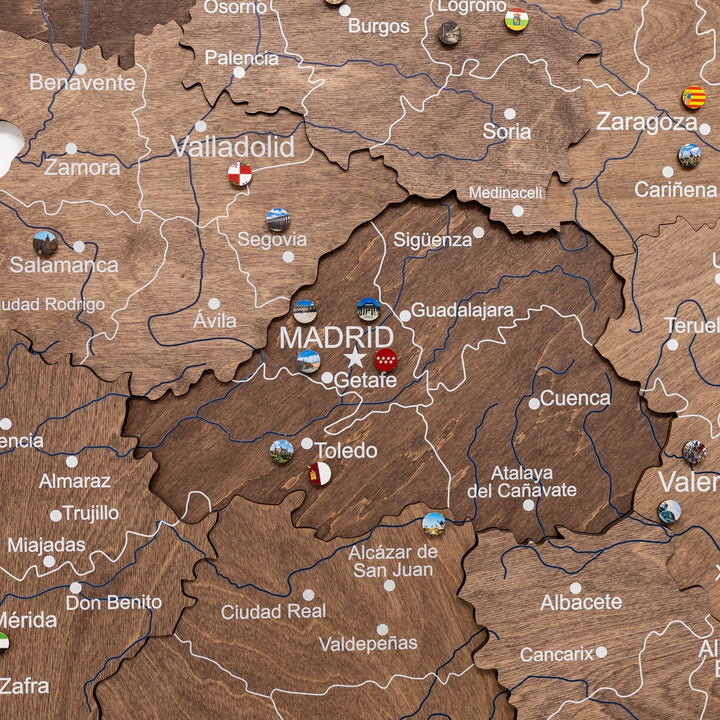 Dark walnut wooden Spain map close-up with Madrid label and route lines