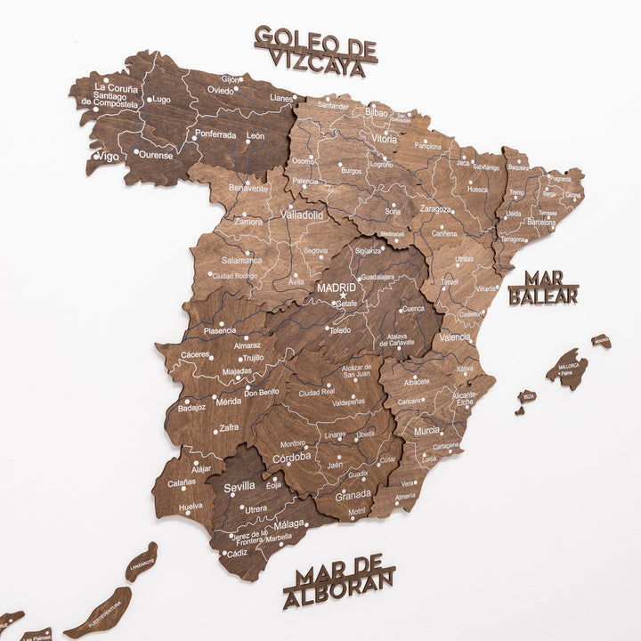 Dark walnut 3D wooden Spain map with region borders, city names, and flag markers