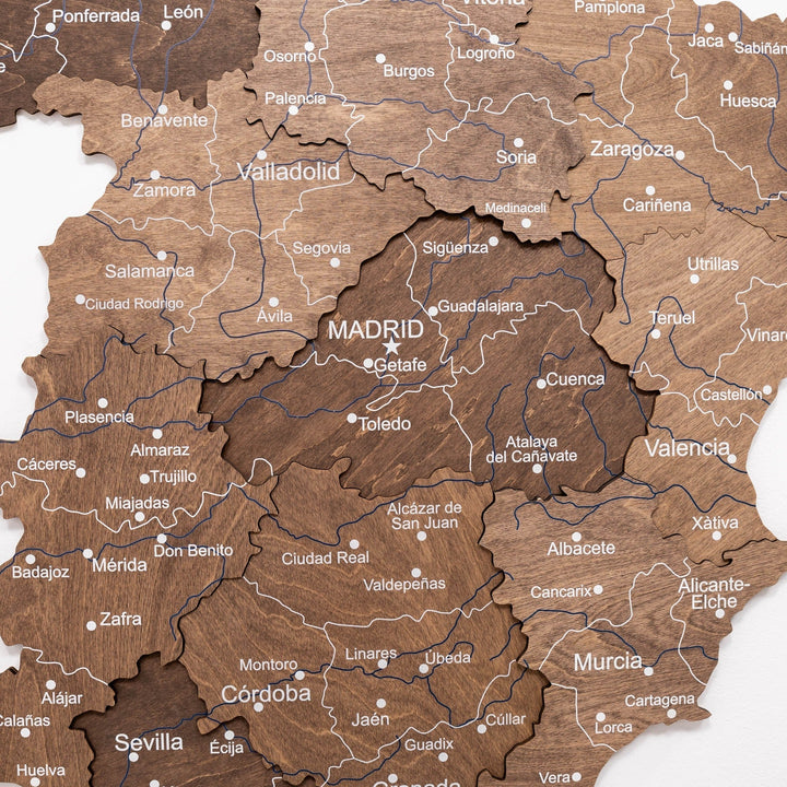 Dark walnut wooden Spain map close-up with city labels and route lines