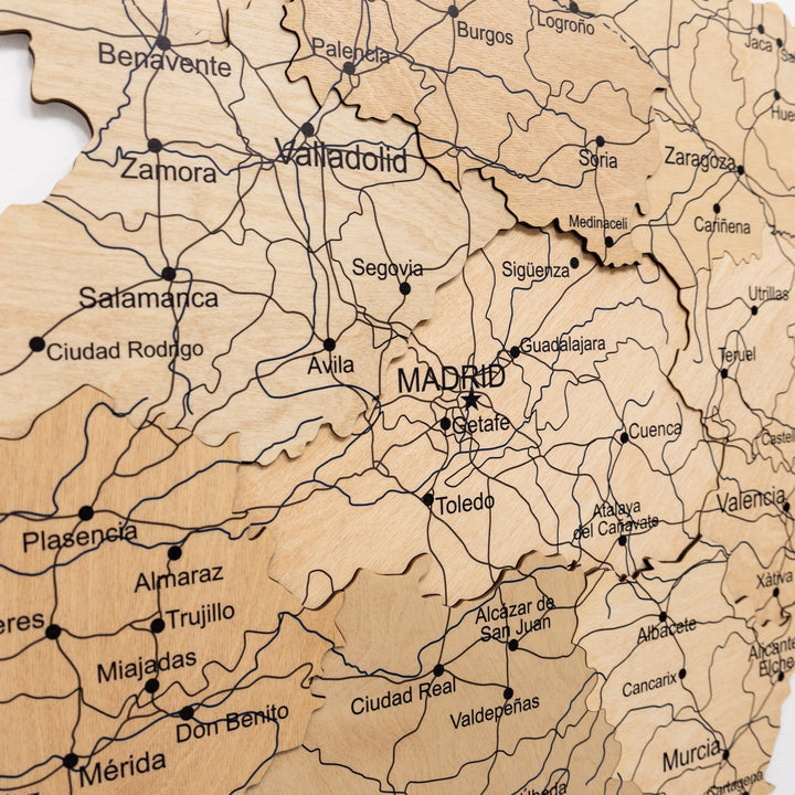 Close-up of gold wooden map of Spain with dense town labels and connecting road lines