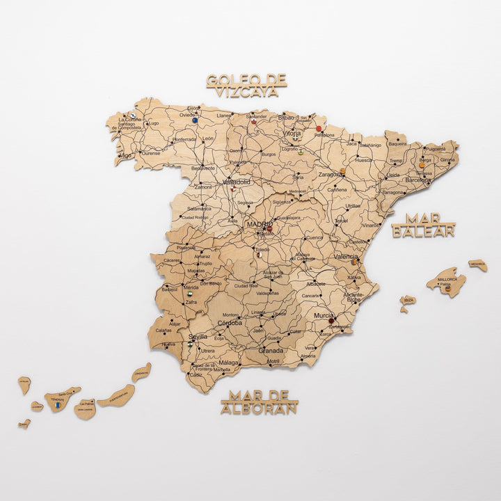 Gold wooden Spain map with islands pieces and text markers for seas around the board