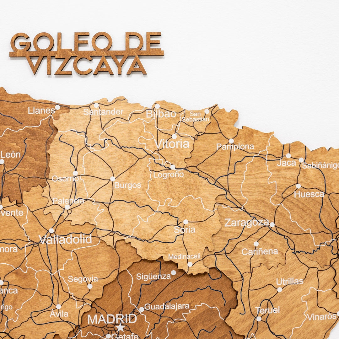 Oak wooden map of Spain with engraved roads and city names, featuring the Madrid area