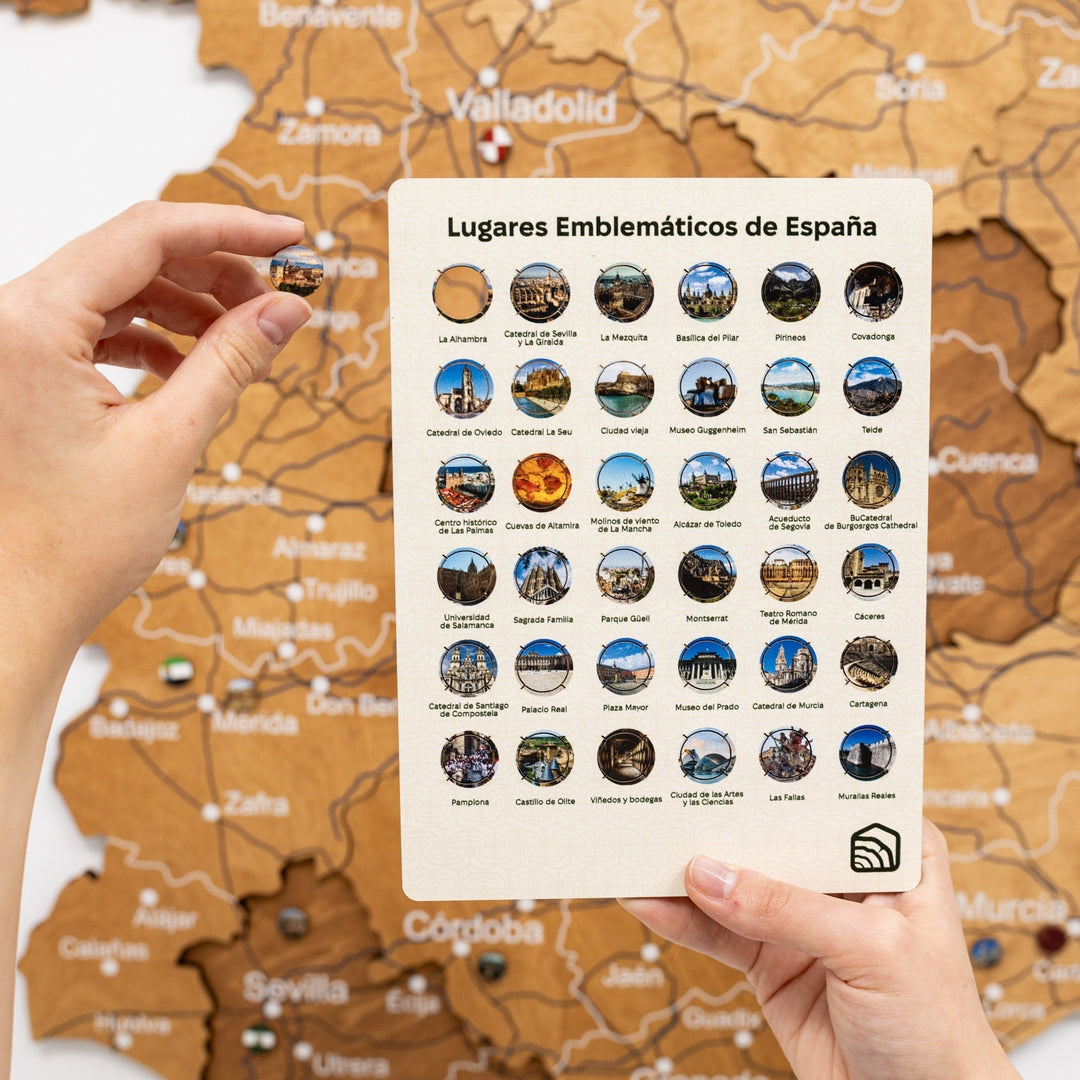 Oak wooden map of Spain with a guide card showing featured locations and color pins