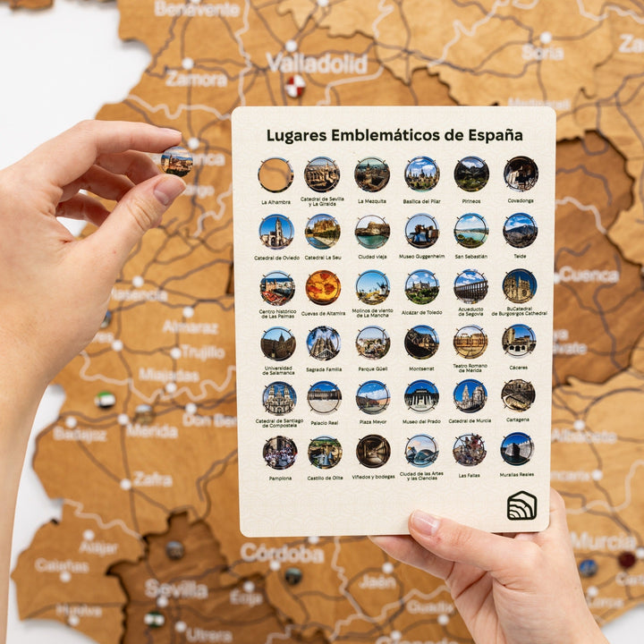 Oak wooden map of Spain with a guide card showing featured locations and color pins