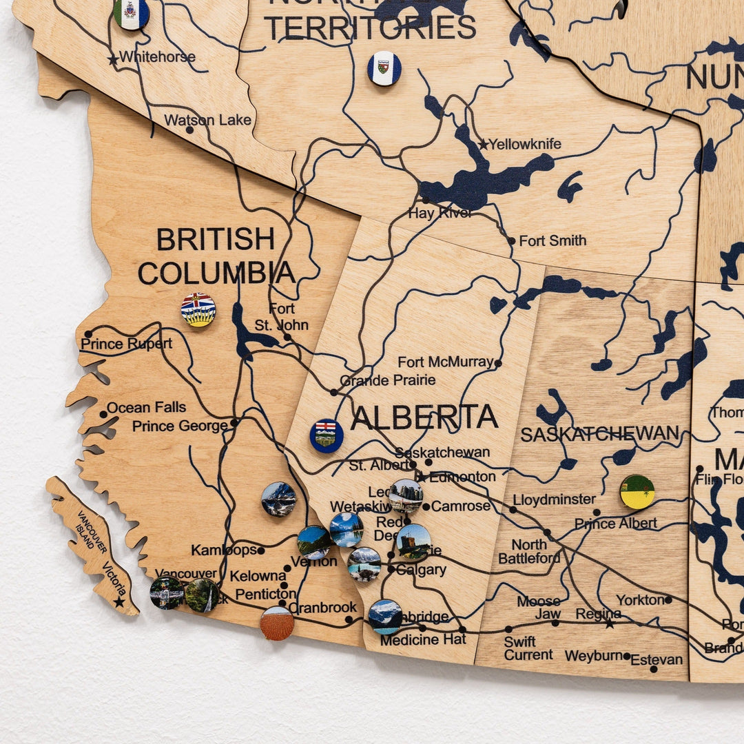 Close-up of Alberta and Saskatchewan on wooden 3D Canada map with town labels and pins