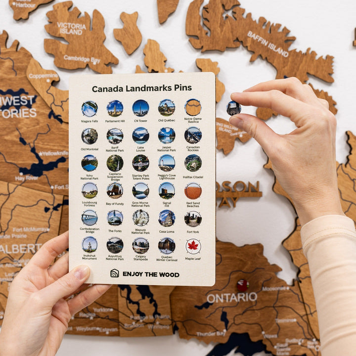 Canada Landmarks Pins card with many pin icons; shown with the wooden Canada map