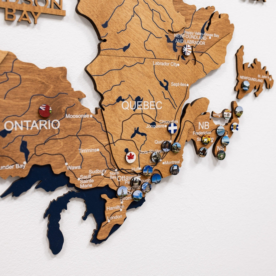 Wooden Canada wall map with engraved labels and small round souvenir pins