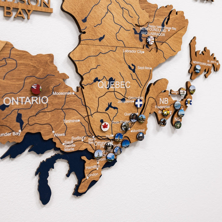 Wooden Canada wall map with engraved labels and small round souvenir pins