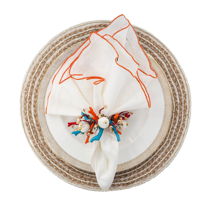 Set of 4 white linen napkins with orange ruffled hemstitch edges, round folded display