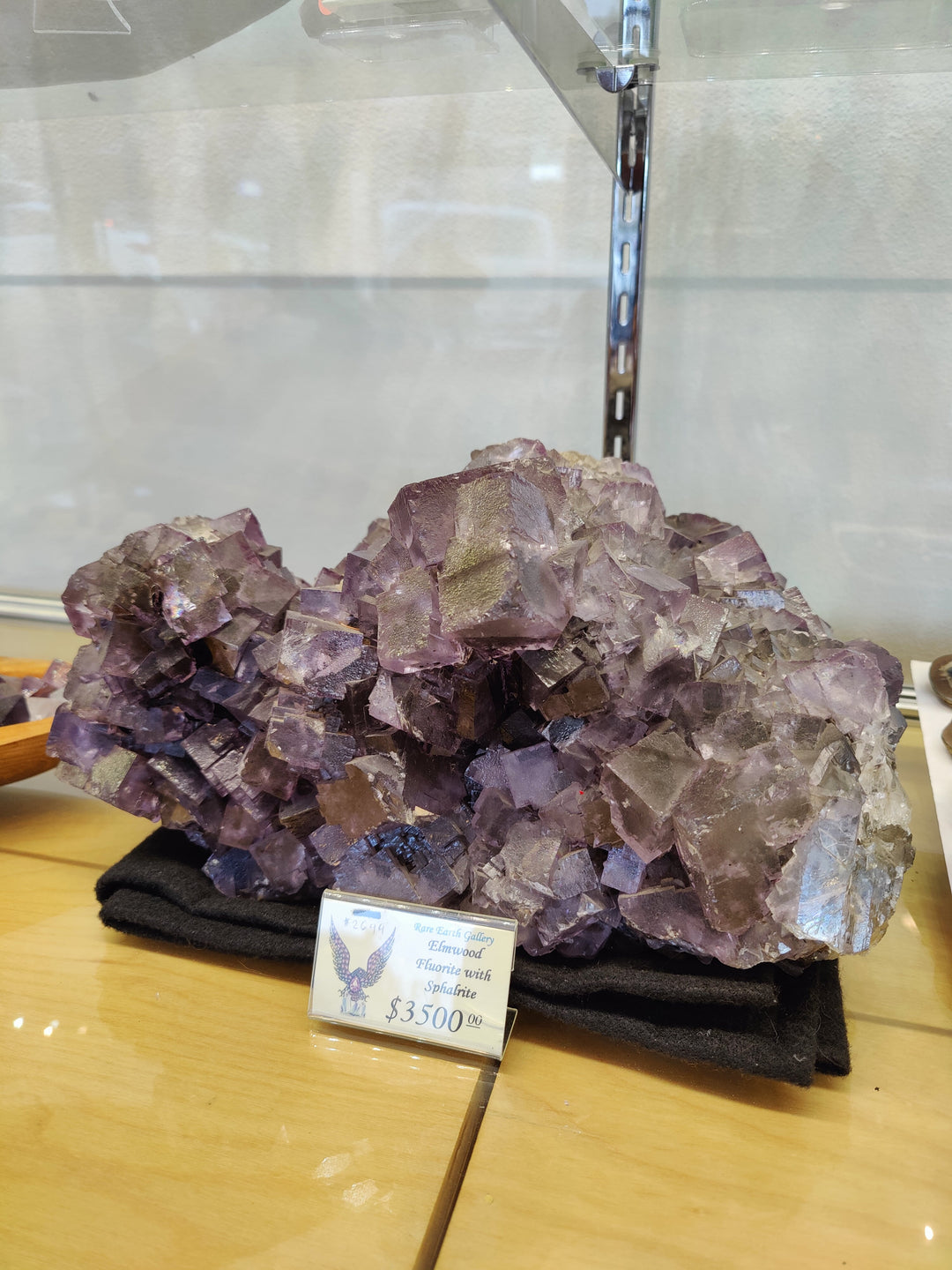 Large amethyst-purple fluorite crystal cluster with jagged cubic faces on dark base