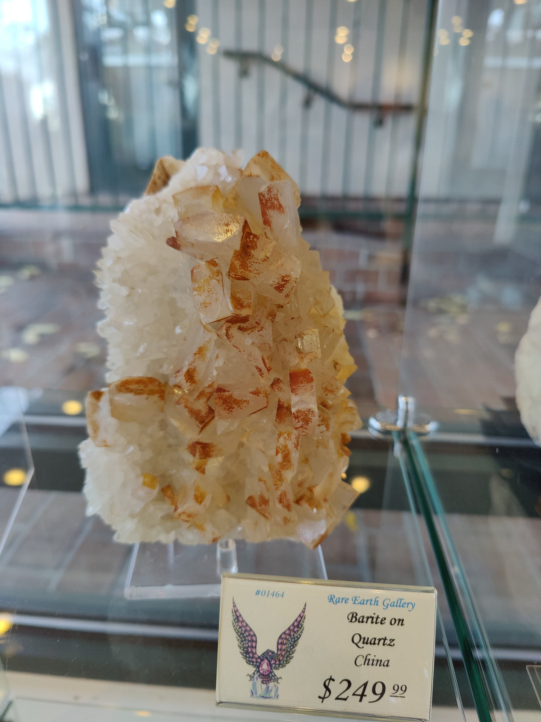 Orange barite on white quartz crystal cluster with clear stand and price card