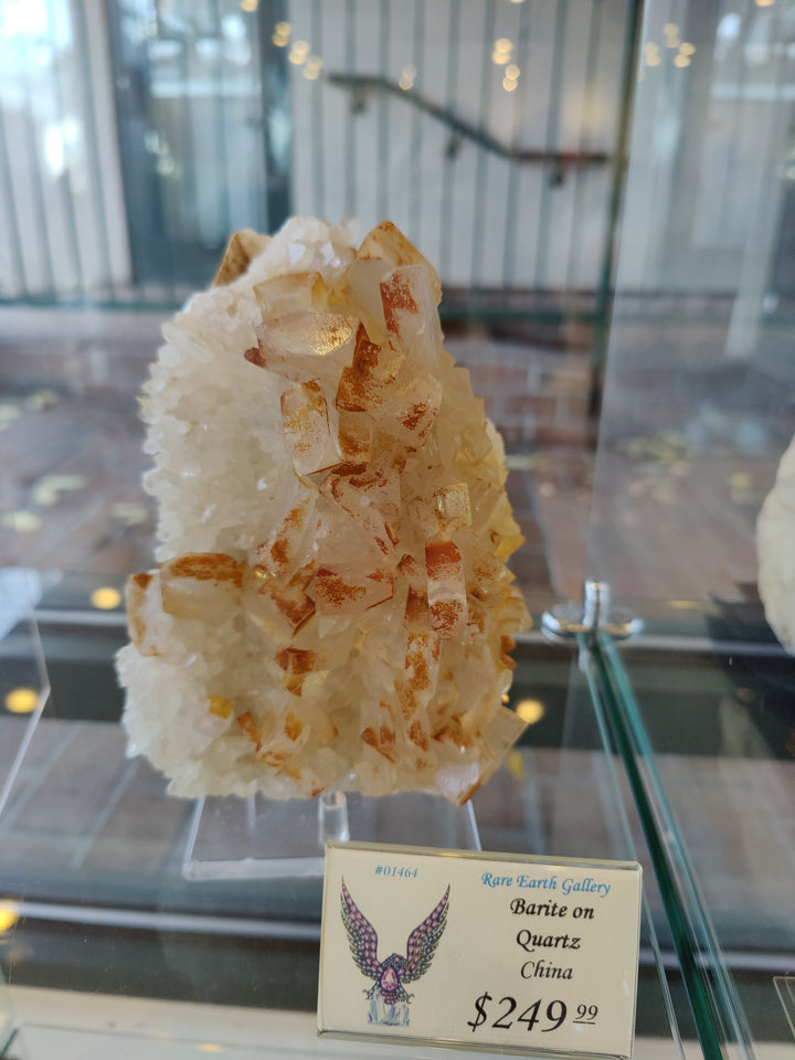 Orange barite on white quartz crystal cluster with clear stand and price card