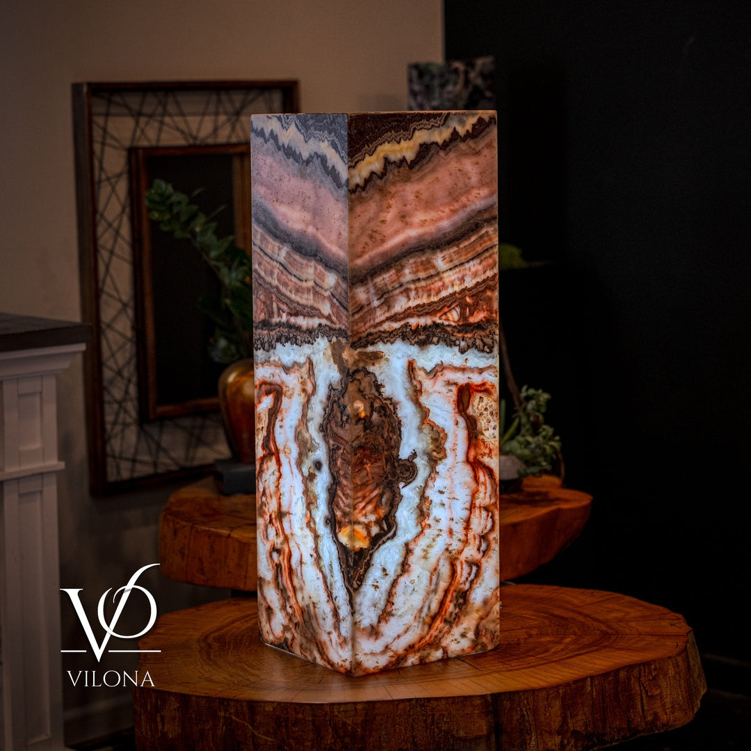 Small square floor lamp with multi-color agate-pattern shade, standing on round wood table