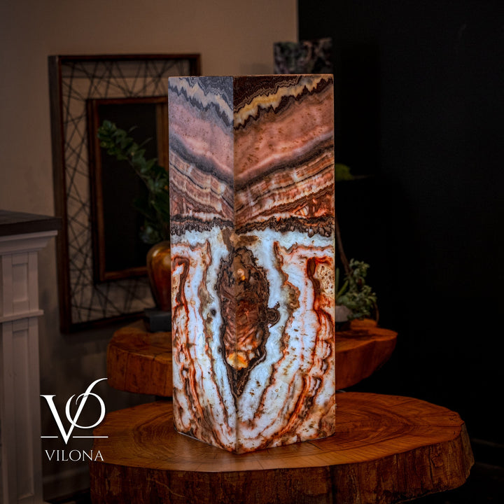 Small square floor lamp with multi-color agate-pattern shade, standing on round wood table