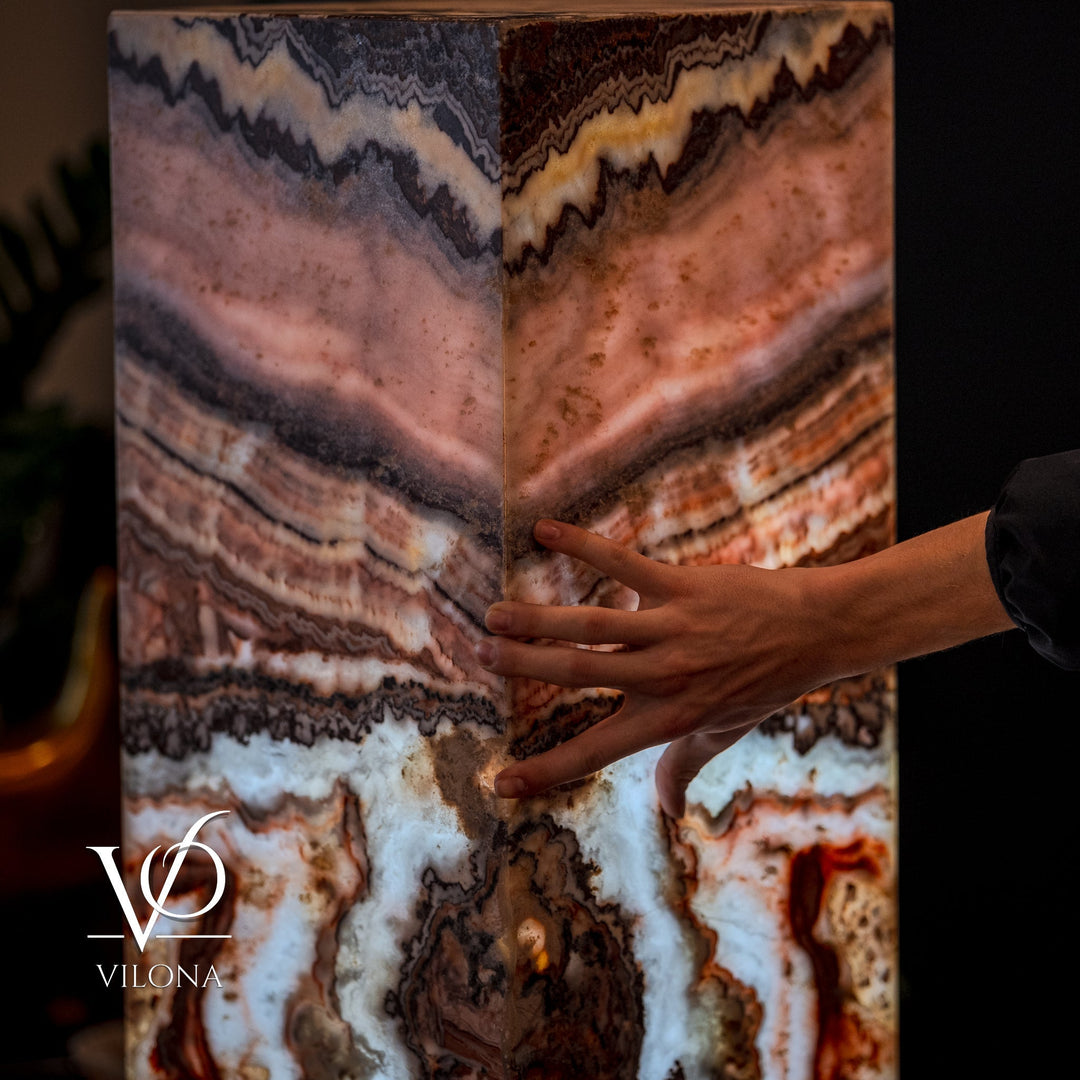 Small square floor lamp with multi-color agate-pattern shade; hands hold the sides