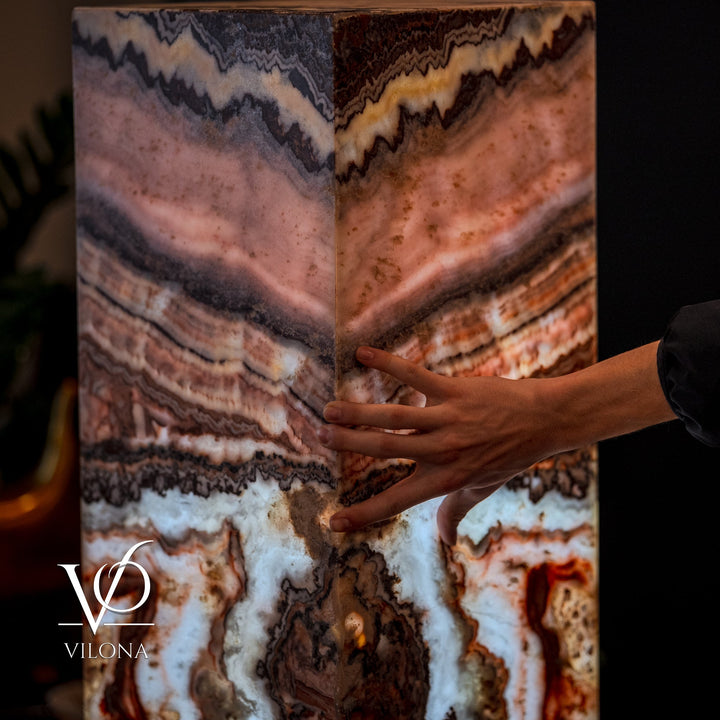 Small square floor lamp with multi-color agate-pattern shade; hands hold the sides