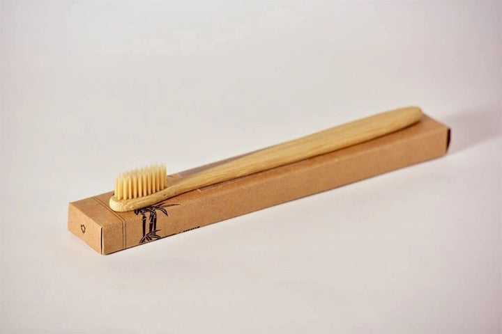 Bamboo toothbrush in cardboard box, soft bristles facing outward