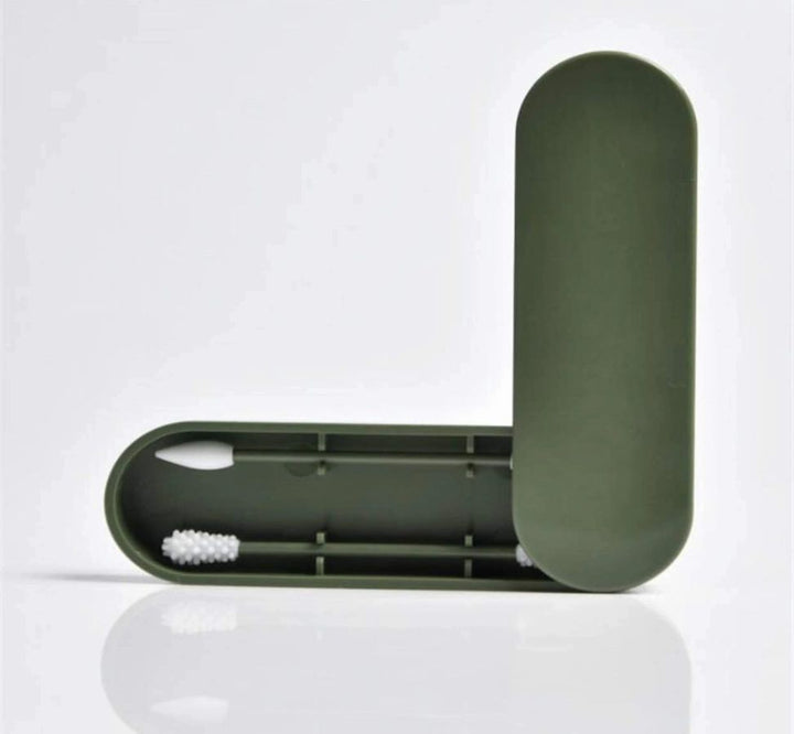 Dark green travel case with white facial brush inside
