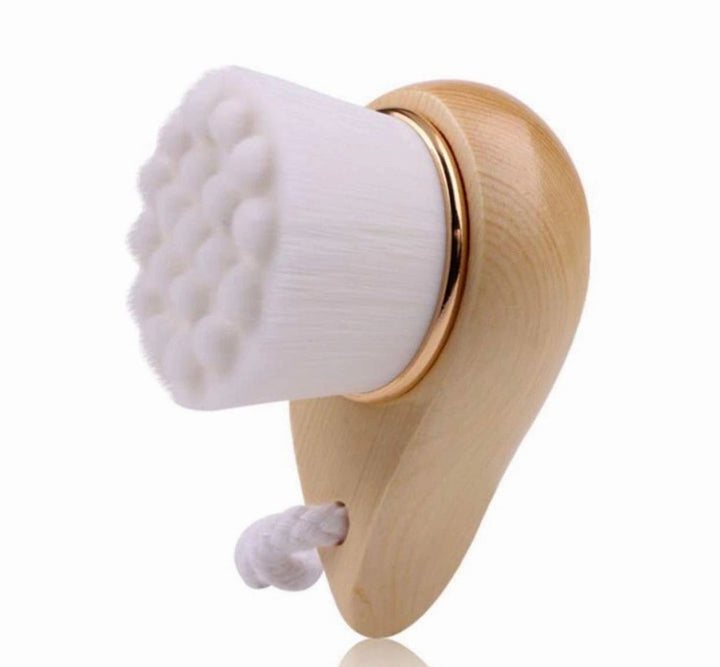 Wooden-handled facial brush with white textured bristle pad