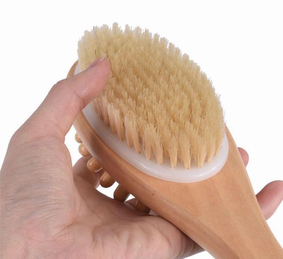 Massage body brush with light tan bristle head and translucent white handle