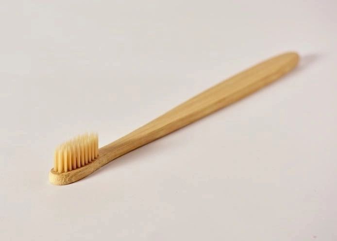 Toothbrush head with soft bristles and bamboo handle, close-up