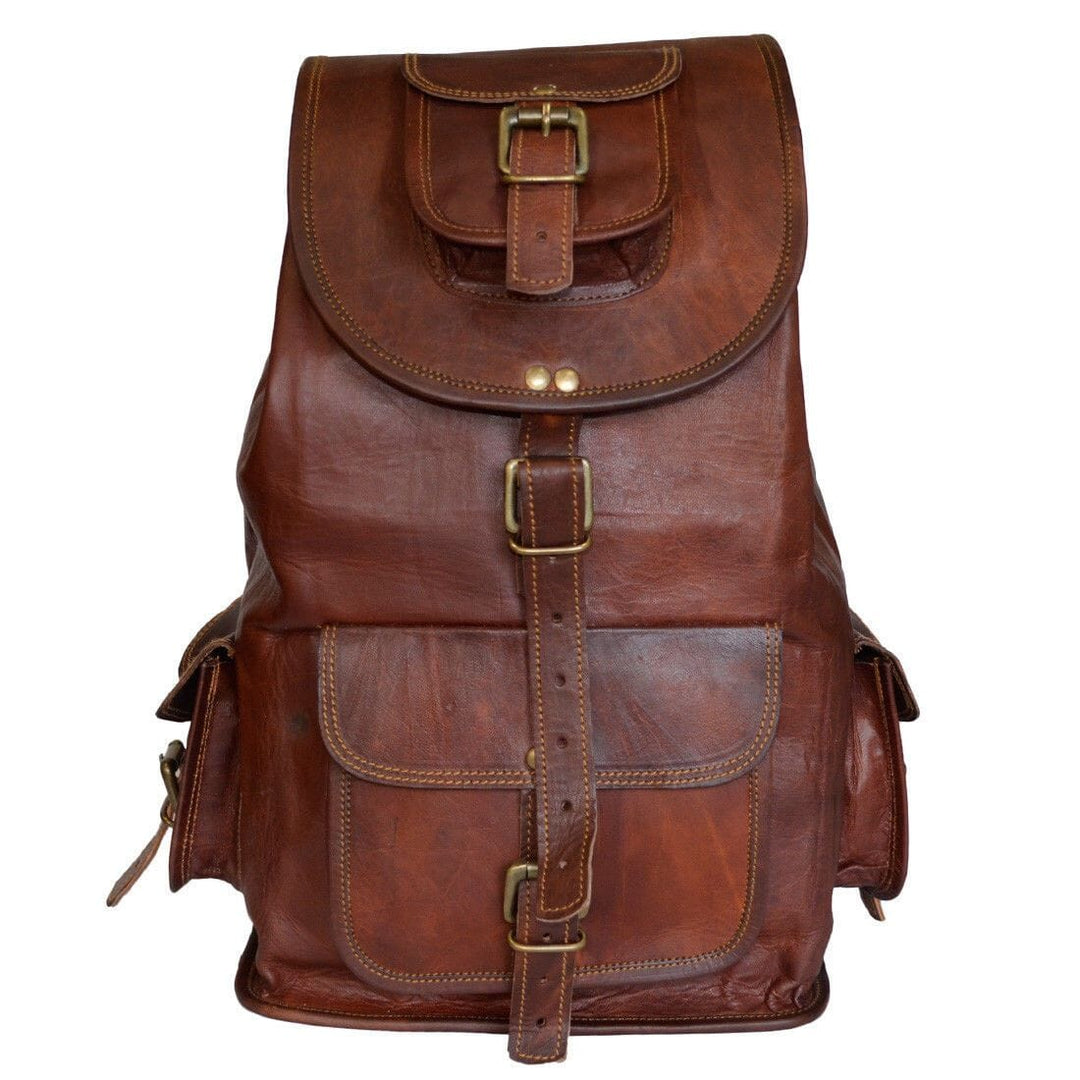 Brown leather hiking backpack with front flap, buckled straps and top handle.
